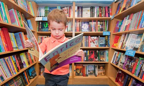 A boy reading a book in a bookshops