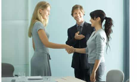 Businessman introducing teenage girl to young professional woman