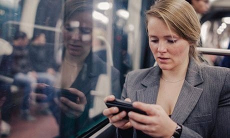 Salesforce: Woman using smart phone in subway.