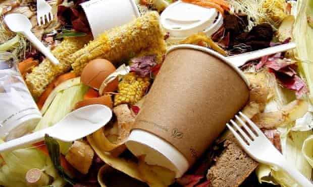 Food waste along with cutlery and paper cups