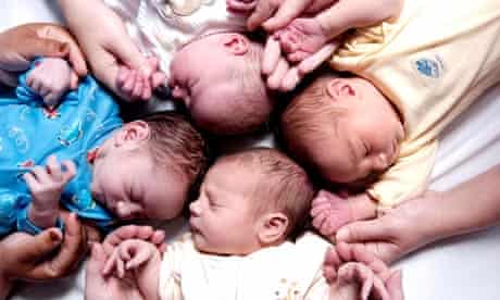 Newly born day old babies and mothers hands seen in an NHS maternity unit