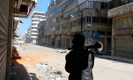 A man carries a rocket propelled grenade in the al-Hamidiya neighbourhood of Homs, Syria