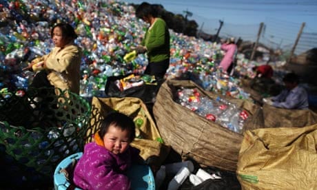 People sort out empty plastic bottles in a recycling centre in Changping district in Beijing, China