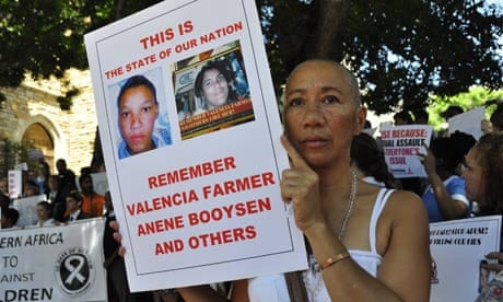 Tina Schouw, a South African singer holds a poster  of Anene Booysen