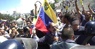 Former president of Petroleos de Venezuela, General Guicaipuro Lameda, holding the national flag