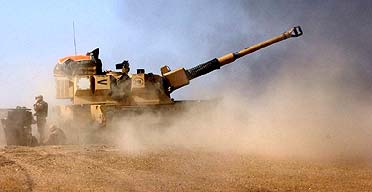 A British Army AS90 gun fires at Iraqi positions 