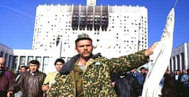 A hardline defender of the Russian White House leaves the parliament building, in Moscow, to surrender on October 4 1993