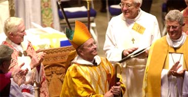 Gene Robinson smiles as he is introduced as bishop in Durham, New Hampshire