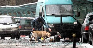 A police officer works with a sniffer dog at the site of an explosion outside the National hotel in central Moscow