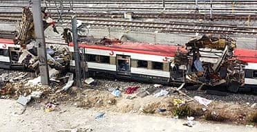 Destroyed railway carriages sit on the tracks after a bomb exploded in the Atocha railway station in Madrid