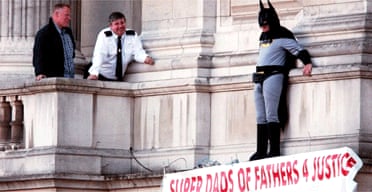 Police talk to Fathers 4 Justice campaigner Jason Hatch during his Buckingham Palace protest