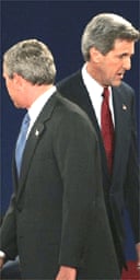 George Bush crosses the path of John Kerry during the presidential debate at Washington University in St Louis, Missouri