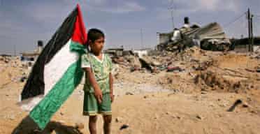 A Palestinian boy among the demolished homes of Jabaliya refugee camp