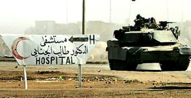 A US army tank rolls down the main street in Falluja