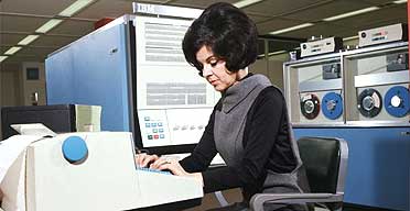 Operator using a 1960s IBM computer