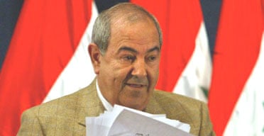 The Iraqi prime minister, Ayad Allawi, gathers his papers after briefing reporters in Baghdad. Photograph: Chris Helgren/AP
