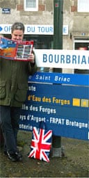 Stephen Moss reads an estate agents brochure in Bourbriac, France