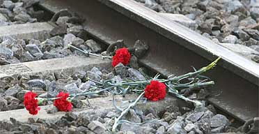 Flowers lie on the railway tracks at El Pozo station in memory of the Madrid train bombing victims
