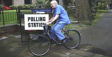 A voter heads off on a bicycle after casting his vote