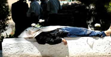 A corpse lays on slab in the centre of the Uzbek town of Andijan