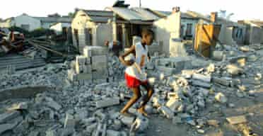 A child jumps through the ruins of houses destroyed in the Zimbabwean government's campaign that it claims is to restore order to Harare's slums. Photograph: AP