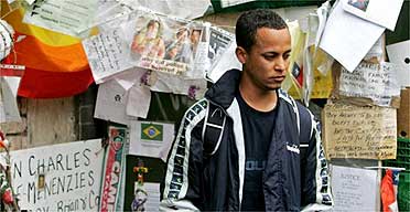 Alessandro Pereira, cousin of Jean Charles de Menezes, stands beside tributes at Stockwell tube station