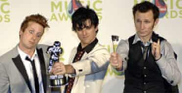 Green Day pose with one of the six trophies they won at the MTV music video awards in Miami. Photograph: Stan Honda/AFP
