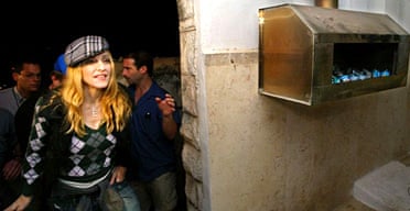 Madonna visits a Kabbalist tomb on a trip to Israel hosted by Shaul Youdkevitch, director of the Kabbalah Centre in Tel Aviv. Photograph: Pedro Ugarte/Getty