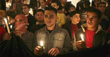 Jordanians hold candles during a vigil on the entrance steps of the SAS Radisson hotel to commemorate the suicide bombings. Photograph: Marco Di Lauro/Getty