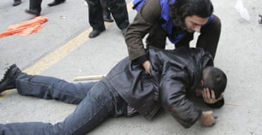 A man helps a demonstrator lying on the ground during an opppositin protest in Baku, Azerbaijan