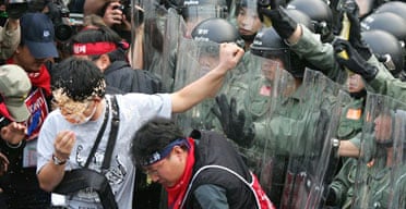 Hong Kong riot police use pepper spray to prevent South Korean anti-globalisation protesters marching on the main venue for WTO talks. Photograph: Claro Cortes IV/Reuters