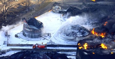 An aerial photograph released today by Hertforshire police shows foam being sprayed onto burning oil storage tanks at the Buncefield oil depot. Photograph: AFP/Getty Images