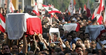 Mourners carry the coffin of anti-Syrian newspaper owner and politician Gibran Tueni, draped in a Lebanese flag