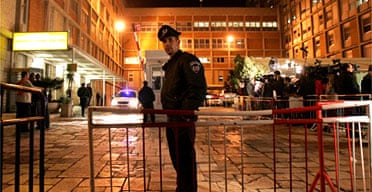 An Israeli policeman stands outside the emergency room of the Hadassah hospital in Jerusalem where Ariel Sharon was undergoing surgery after suffering a stroke. Photograph: Oded Balilty/AP