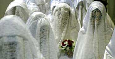 Muslim brides wait for the start of their mass wedding