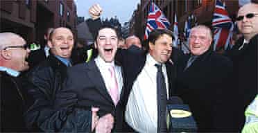 BNP leader Nick Griffin (centre right) and Mark Collett (centre left) leave Leeds crown court