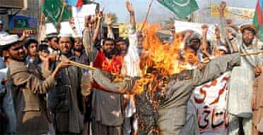 Pakistani religious students burn an effigy of Denmark's PM