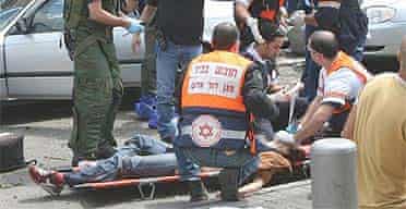 Israeli medics helps people wounded during a suicide attack in Tel Aviv