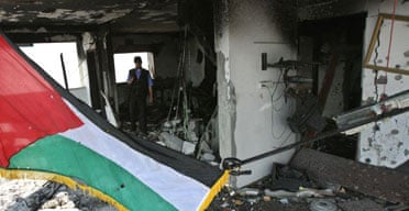 Officials inspect the damage to the Palestinian interior ministry building following Israeli air strikes on Gaza city. Photograph: Mahmud Hams/AFP/Getty Images