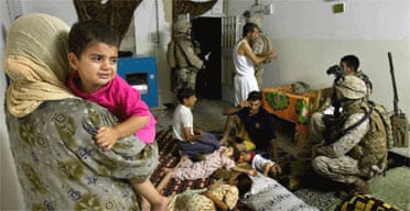US Marines question men in a family house in Ramadi, Iraq
