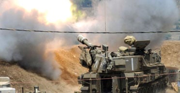 Israeli troops fire artillery shells into southern Lebanon. Photograph: Avihu Shapira/AFP/Getty Images