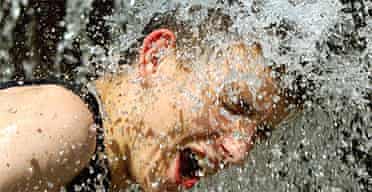 A man cools down in the fountains in Derby city centre