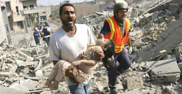 A man screams for help as he carries the body of a dead girl after Israeli air strikes on the southern Lebanese village of Qana