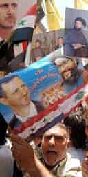 Demonstrators in Damascus carry pictures of Hizbullah leader, Hassan Nasrallah, and Syrian president, Bashar al-Assad