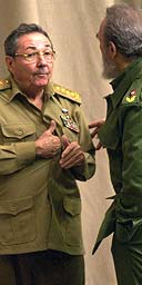 Raul Castro (left) speaks with Fidel at the Convention Palace, Havana