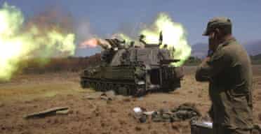 An Israeli artillery unit fires a shell towards Lebanon from its position near the Israeli-Lebanese border. 
