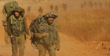 Israeli soldiers cross the border from southern Lebanon back into Israel