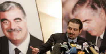 Lebanese anti-Syrian opposition leader, Saad Hariri, son of former prime minister Rafik Hariri, speaks in front of posters of his father in Beirut. Photograph: Hussein Malla/AP 