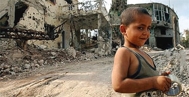 A child plays in the streets of Aitta Shaaba, a village riddled with cluster bombs