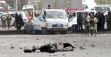 Iraqi security forces gather at the site of a car bomb explosion outside the interior ministry in Baghdad